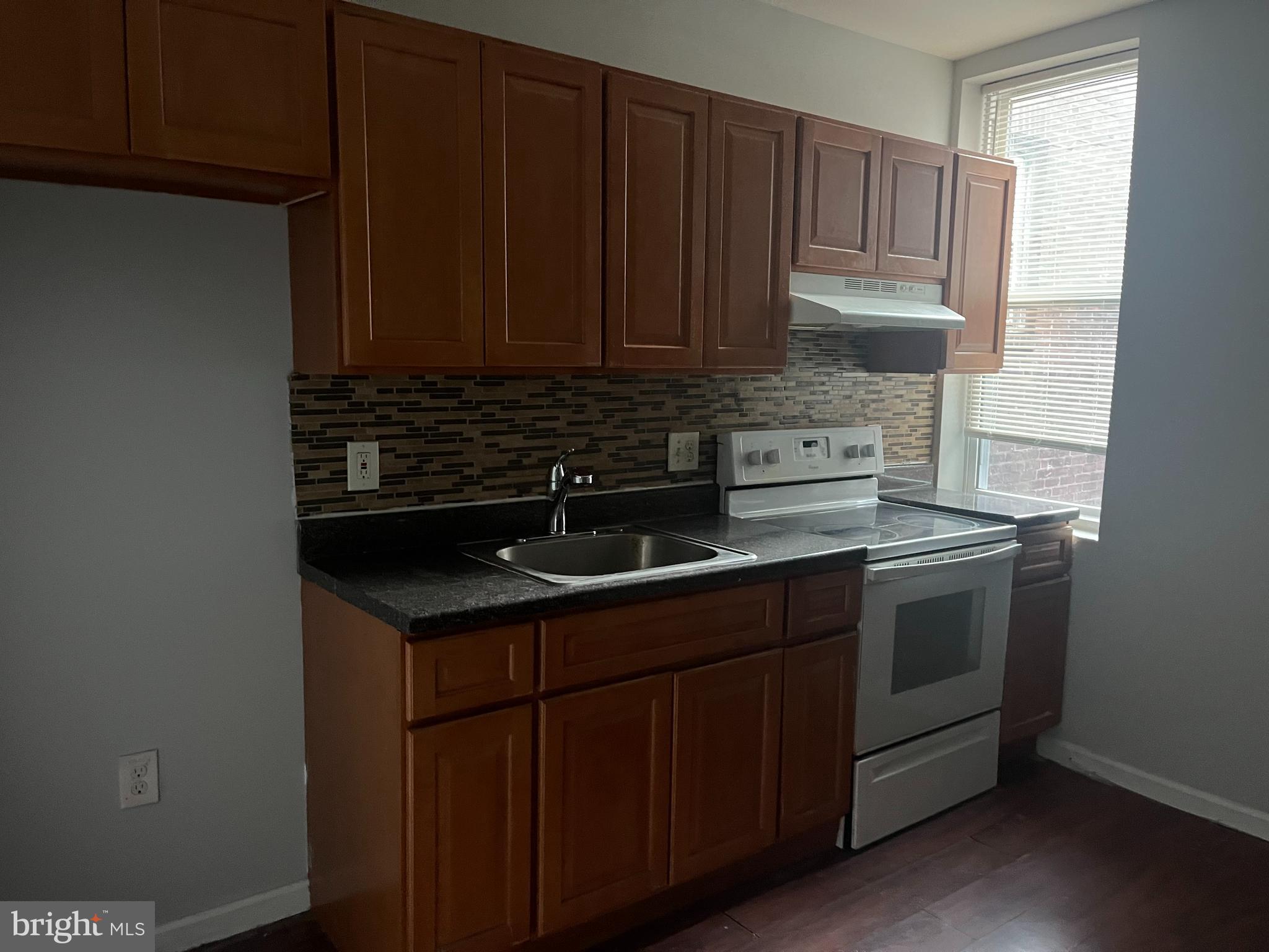 6122 North Broad Street Philadelphia, PA 19141 - Photo 7 of 18 a kitchen with a sink and cabinets