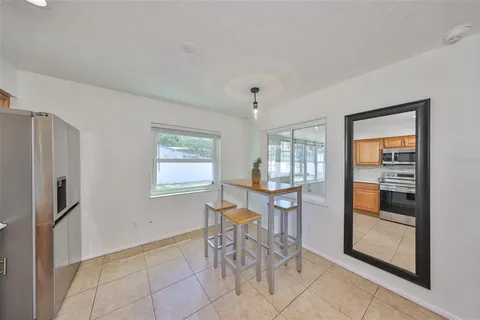 a view of a livingroom with furniture and refrigerator
