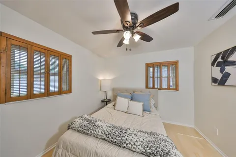 a bedroom with a large bed and a window