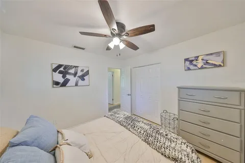 a bedroom with a large bed and a chandelier