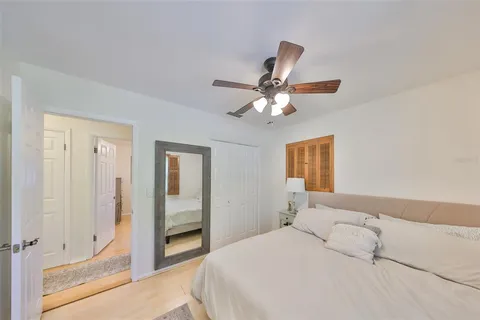 a bedroom with a large bed and a chandelier