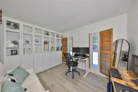 a bedroom with a workspace