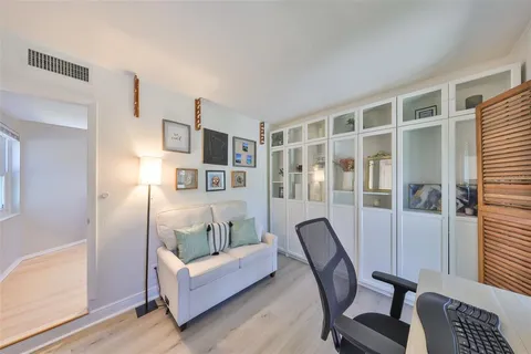 a living room with furniture and a floor to ceiling window