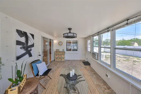 a living room with furniture and a floor to ceiling window