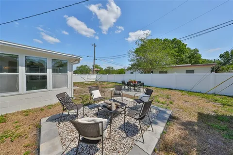 a view of a patio with table and chairs and potted plants