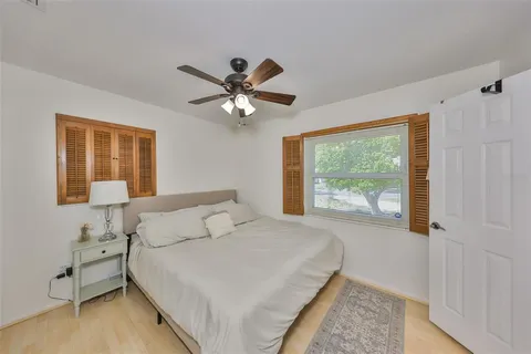 a bedroom with a large bed and a window
