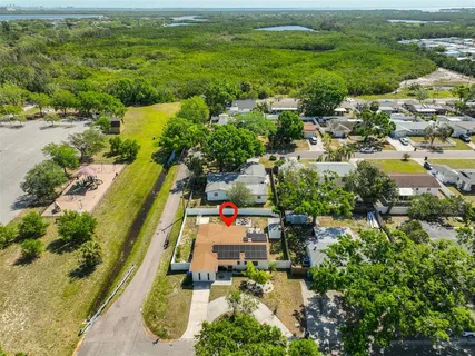 an aerial view of residential houses with outdoor space and swimming pool