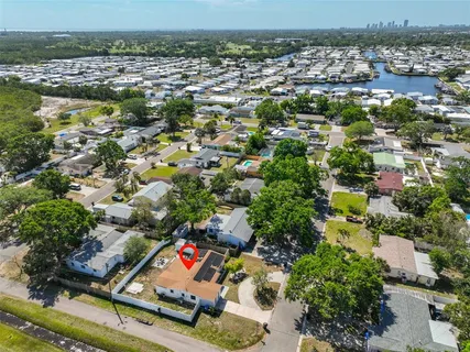 an aerial view of residential houses with outdoor space and swimming pool