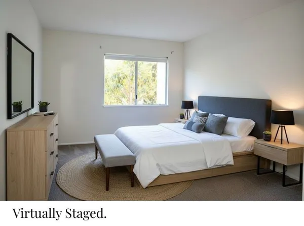 a bed room with a bed window and a television