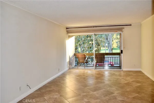 a view of a room with wooden floor and dining room