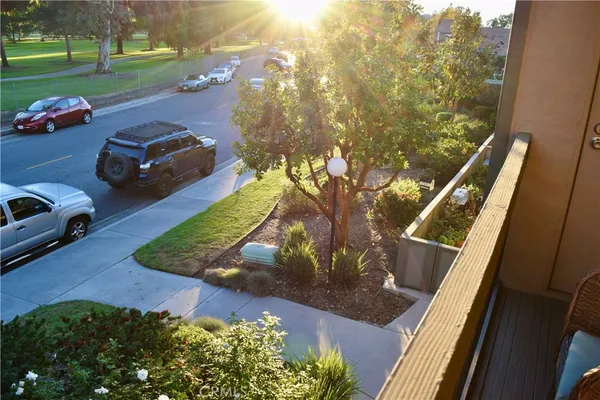 a view of a house with a big yard and large trees