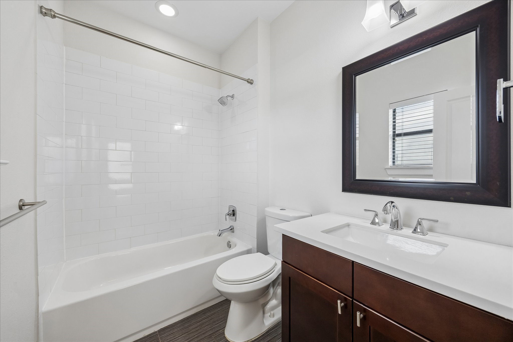 734 West 20th Street, Unit A Houston, TX 77008 - Photo 17 of 23 Third-floor ensuite bath features a tub/shower combo w/ tile surround, large vanity, framed mirror & clean, modern finishes.