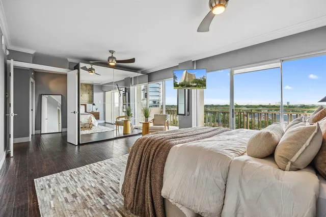 a large bedroom with a bed and wooden floor