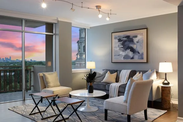 a living room with furniture and a large window