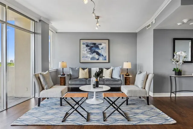 a living room with patio furniture and a rug