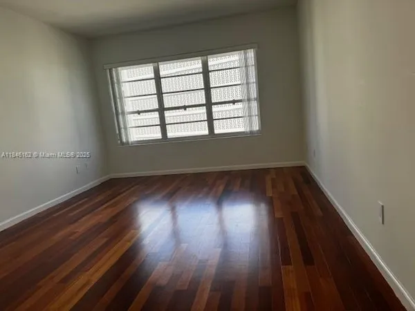 a view of an empty room and floor to ceiling window