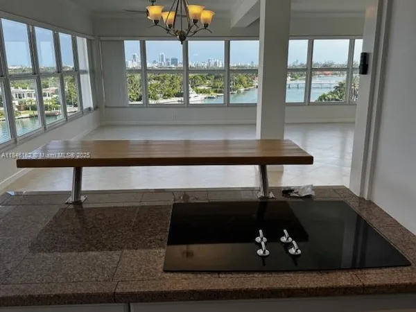 a view of a workspace with furniture and floor to ceiling window