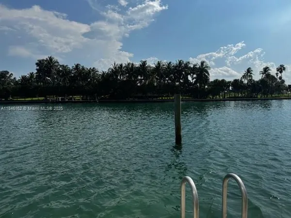 a bathroom with a granite countertop toilet and sink