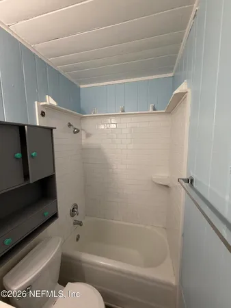 a bathroom with a toilet and a bathtub