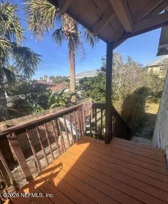 a view of a balcony with wooden floor