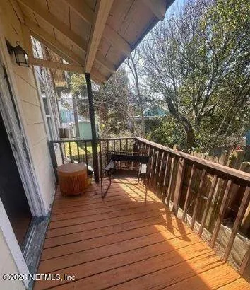 a balcony with wooden floor