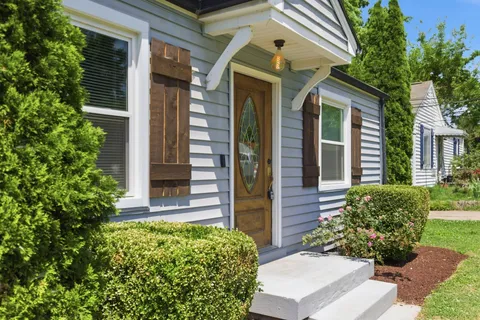a front view of a house with garden