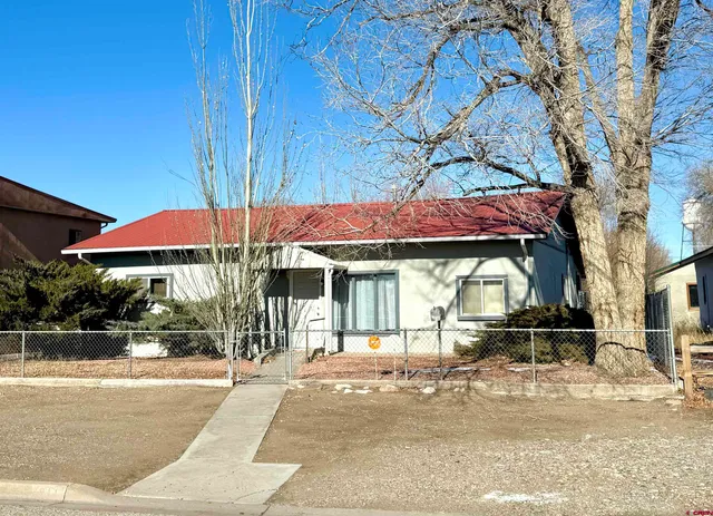 a street view with wooden fence and a umbrellas