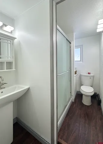 a bathroom with a toilet a sink and mirror