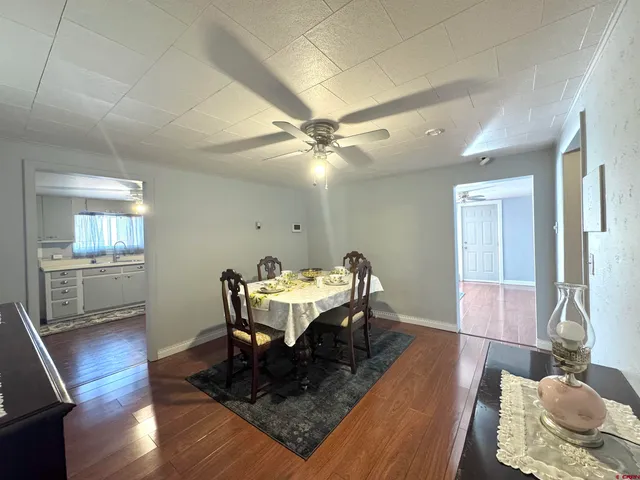 a dining room with furniture and wooden floor