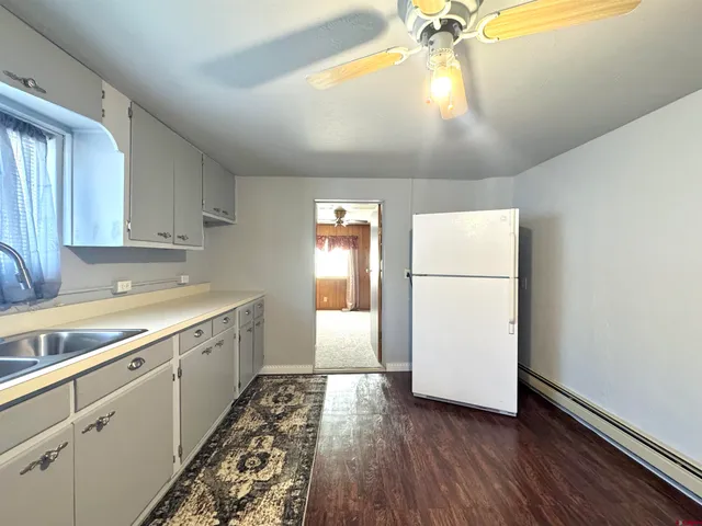 a kitchen with a sink and a refrigerator