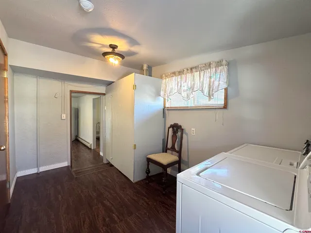 a view of a hallway with wooden cabinet and a chandelier
