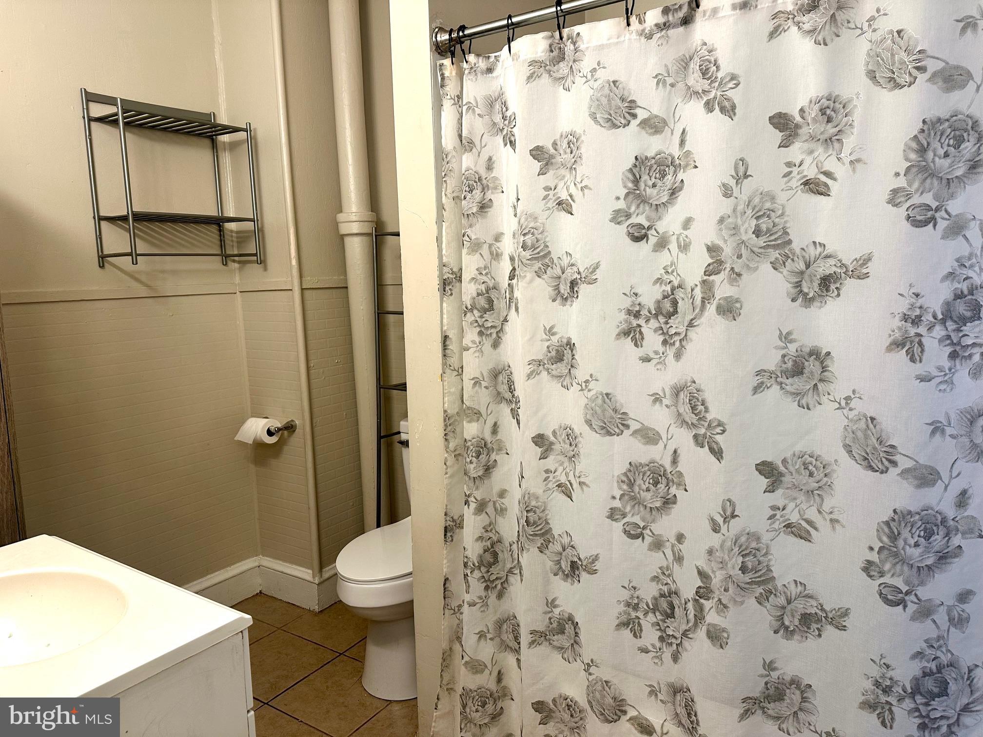 3411 Penn Avenue Sinking Spring, PA 19608 - Photo 11 of 13 a bathroom with a granite countertop toilet and a sink