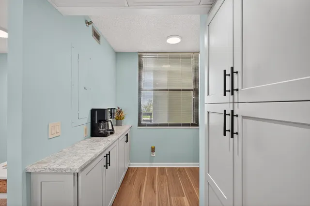 a kitchen with a refrigerator and microwave