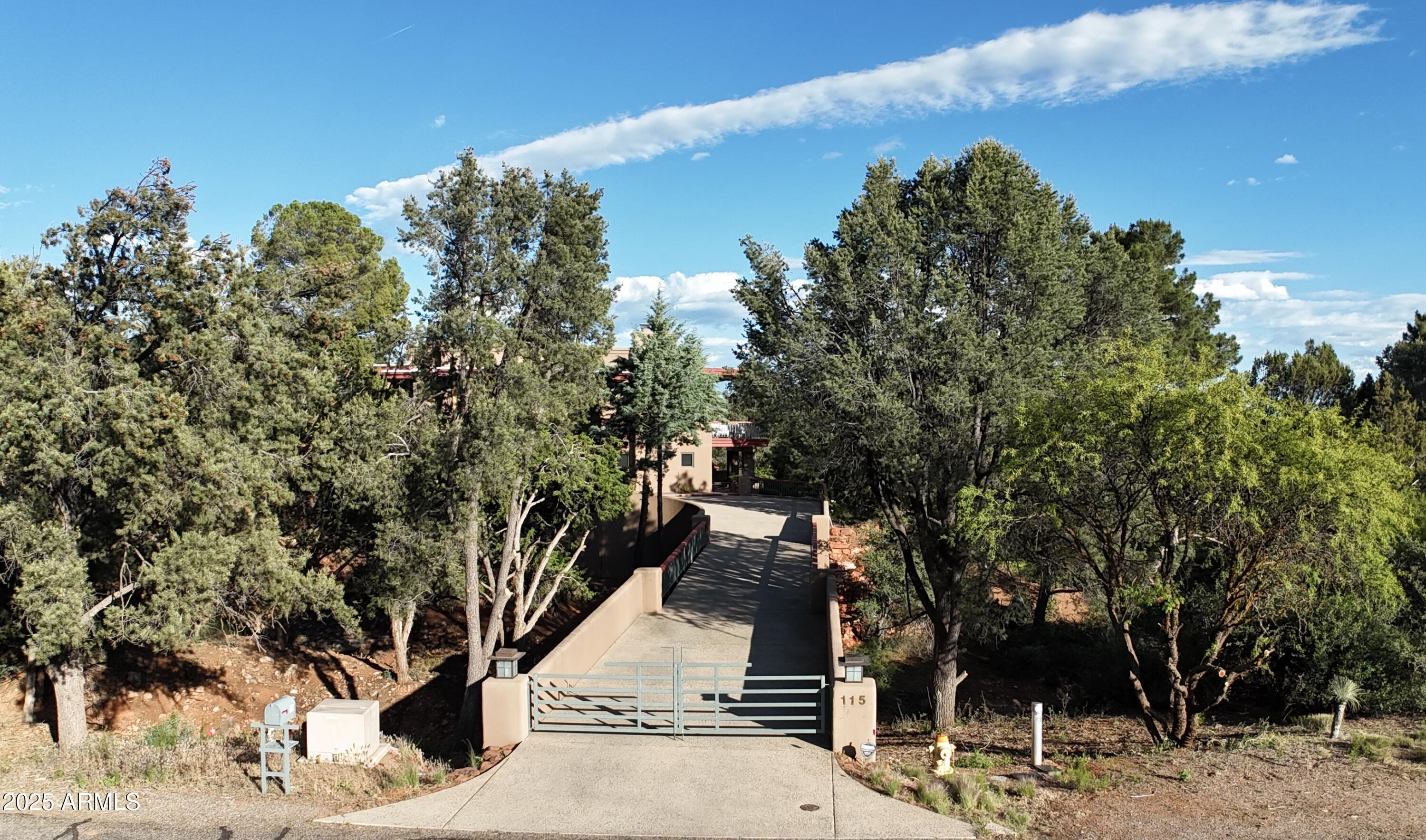 115 Merry Go Round Rock Road Sedona, AZ 86351 - Photo 2 of 33 115 MGRR Drone from gate into driveway