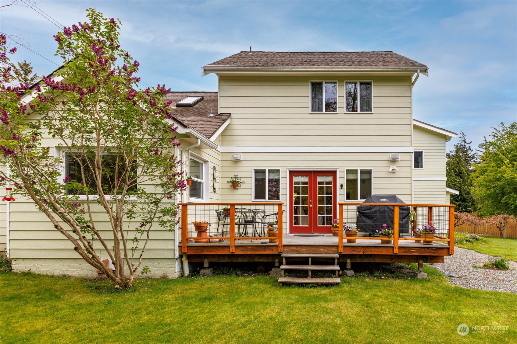 2931 McLeod Road Bellingham, WA 98225 - Photo 31 of 37 a backyard of a house with barbeque oven and table and chairs