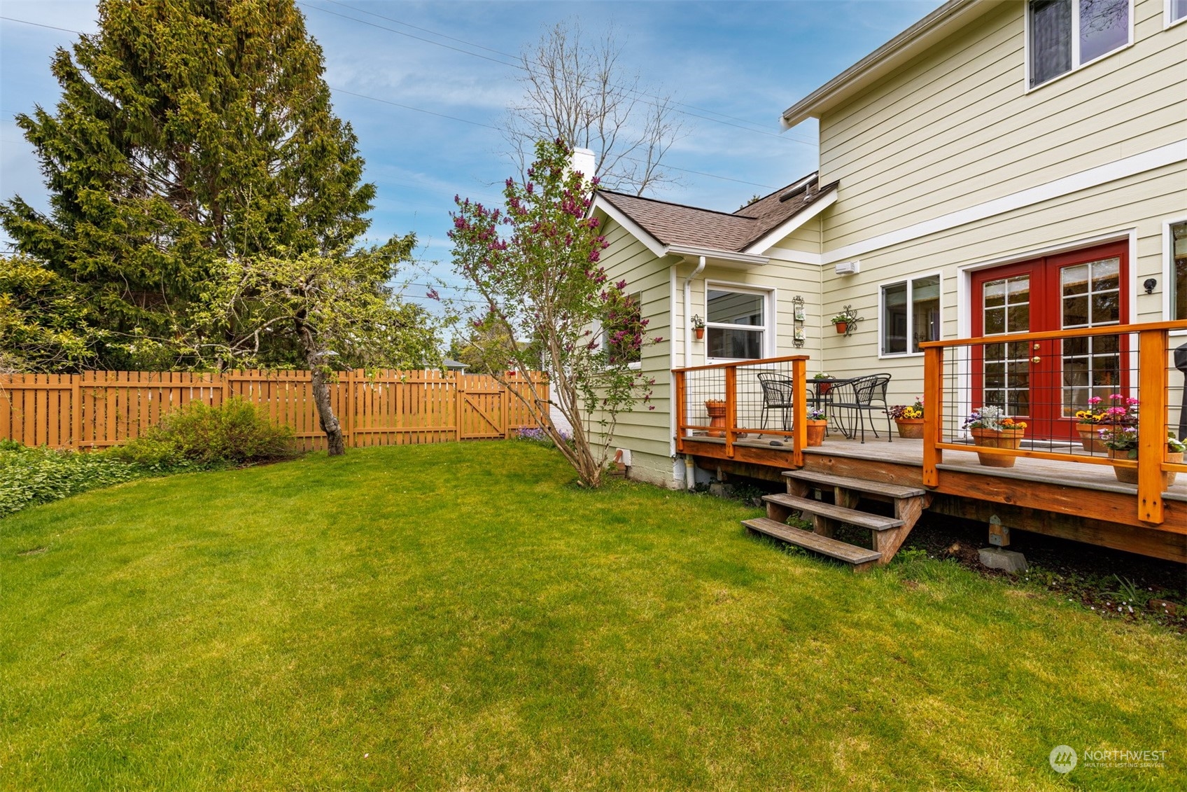 2931 McLeod Road Bellingham, WA 98225 - Photo 34 of 37 a backyard of a house with wooden stairs and bench