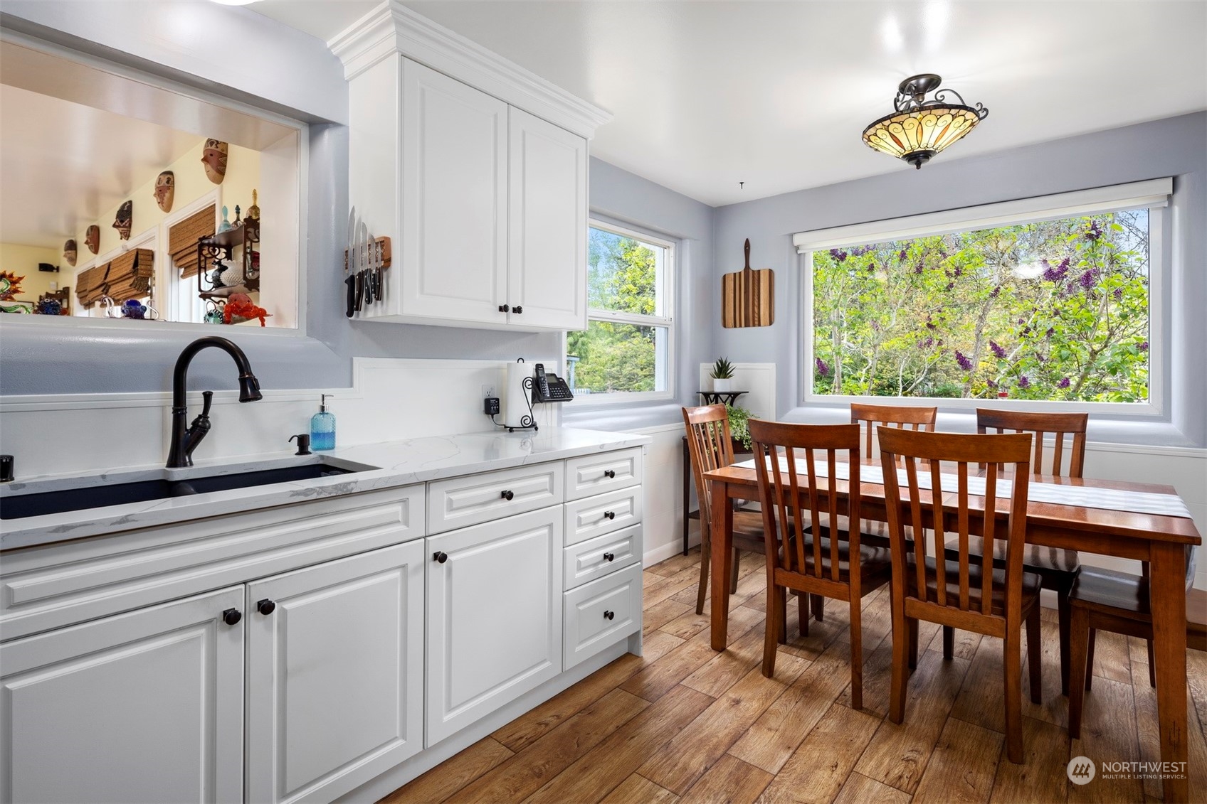 2931 McLeod Road Bellingham, WA 98225 - Photo 8 of 37 a kitchen with a wooden table chairs cabinets and appliances