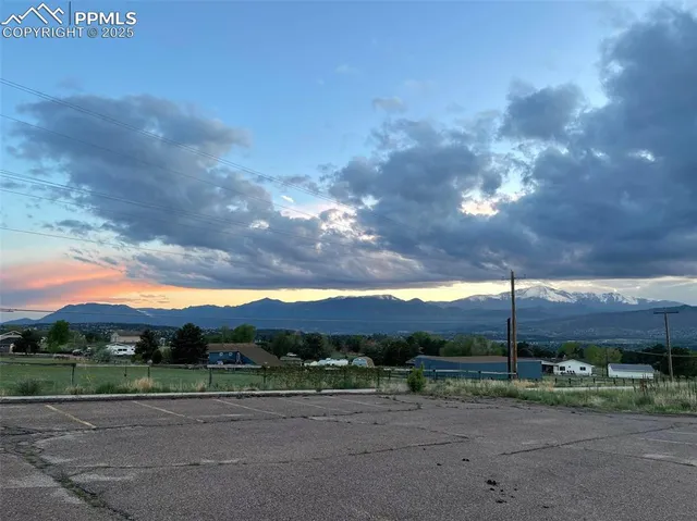 a view of a road with a building in the background