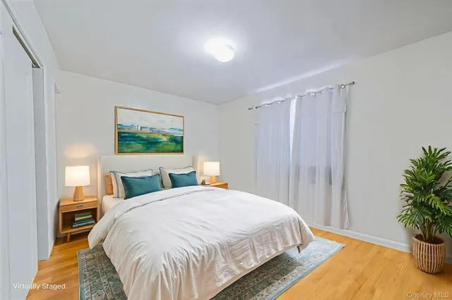 a bed sitting in a bedroom next to a window