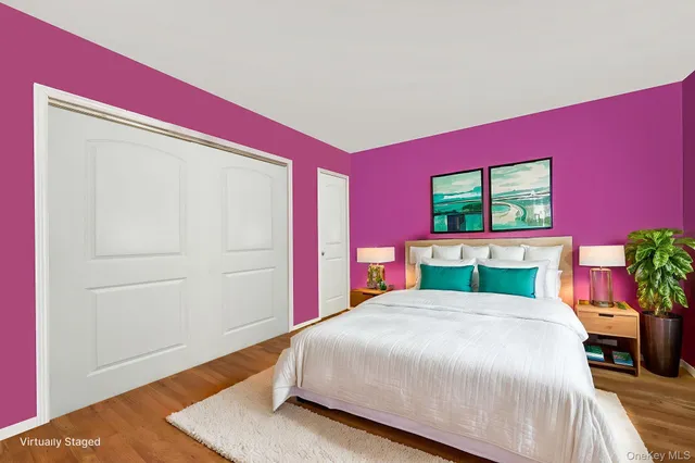 a bedroom with a bed and a potted plant