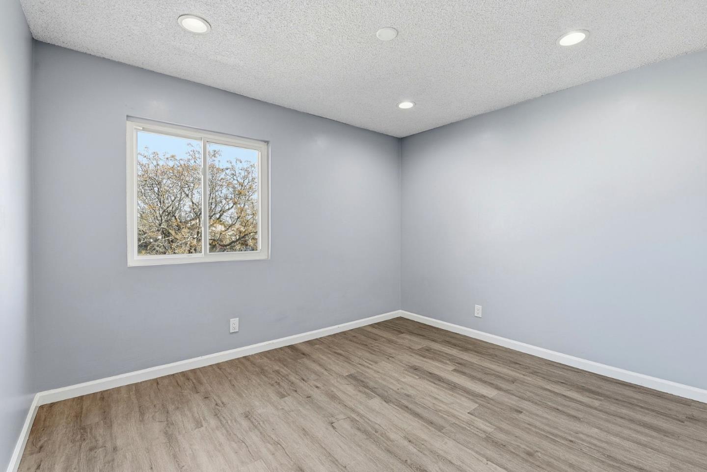 44648 17th Street East Lancaster, CA 93535 - Photo 12 of 21 an empty room with wooden floor and window