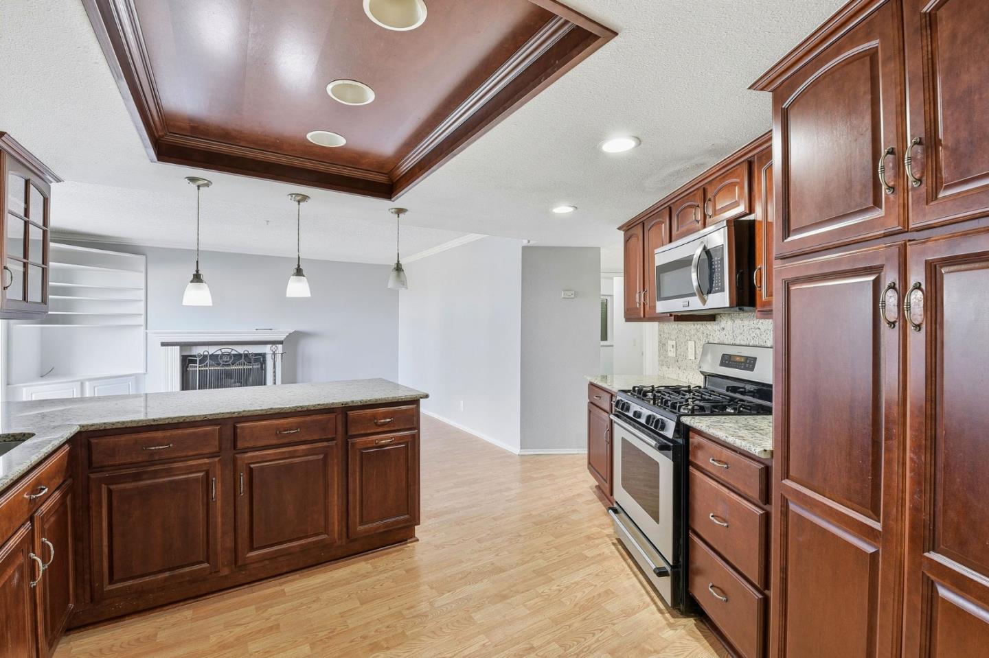 44648 17th Street East Lancaster, CA 93535 - Photo 6 of 21 a kitchen with granite countertop stainless steel appliances and wooden cabinets