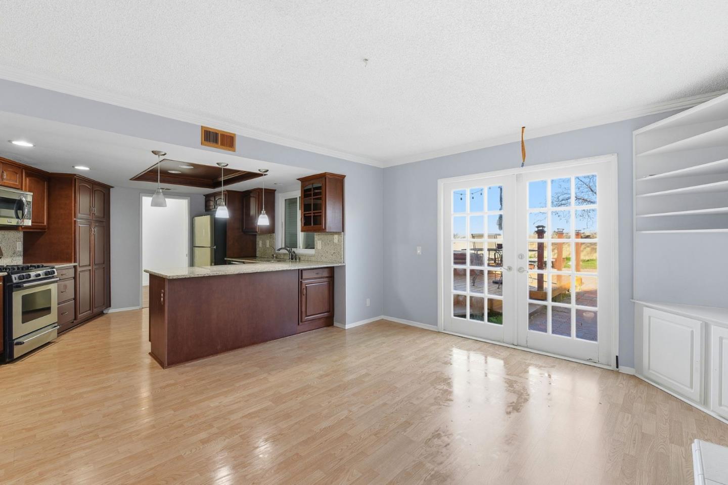 44648 17th Street East Lancaster, CA 93535 - Photo 7 of 21 a large kitchen with stainless steel appliances granite countertop a large counter top and a wooden floors