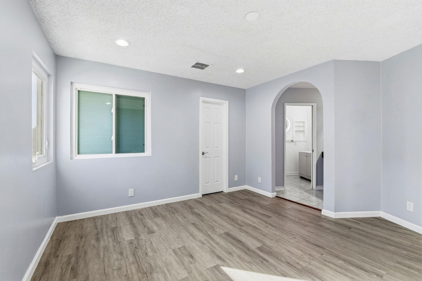 44648 17th Street East Lancaster, CA 93535 - Photo 10 of 21 an empty room with wooden floor and windows