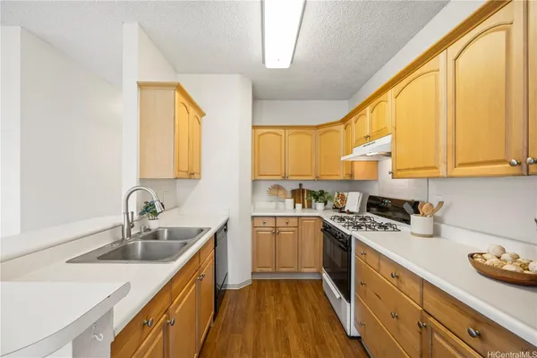 a kitchen with a sink a window and cabinets