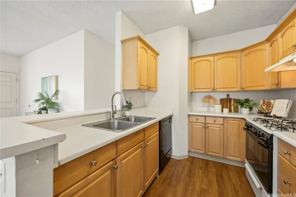 a kitchen with a sink stove and cabinets