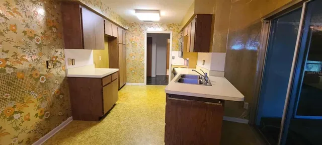 a view of hallway with a bathroom