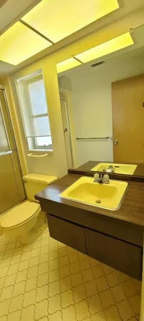 a bathroom with a granite countertop sink and a bathtub