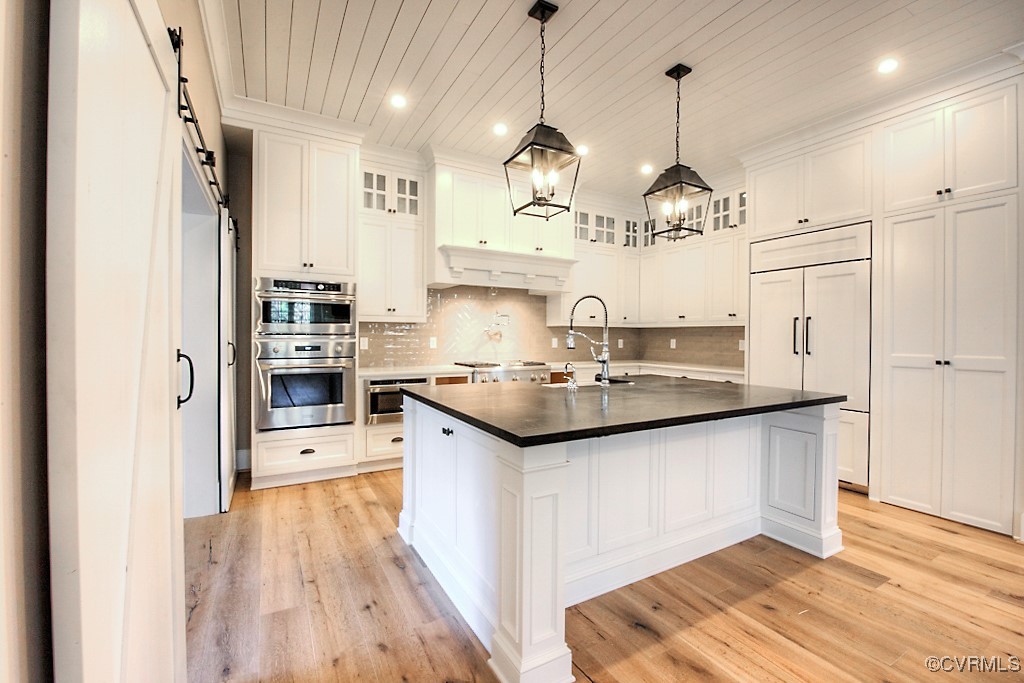 3530 Old Gun Road West Midlothian, VA 23113 - Photo 11 of 37 a kitchen with stainless steel appliances granite countertop a sink a stove a refrigerator and island with wooden floor