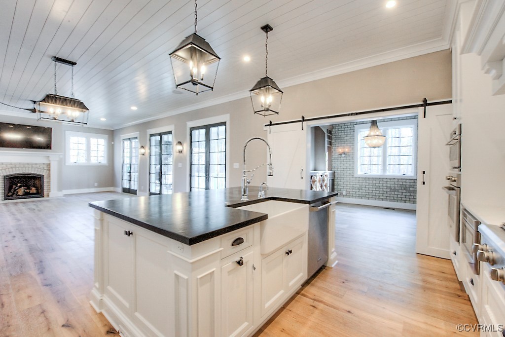 3530 Old Gun Road West Midlothian, VA 23113 - Photo 13 of 37 a kitchen with granite countertop a stove a sink and a wooden floor